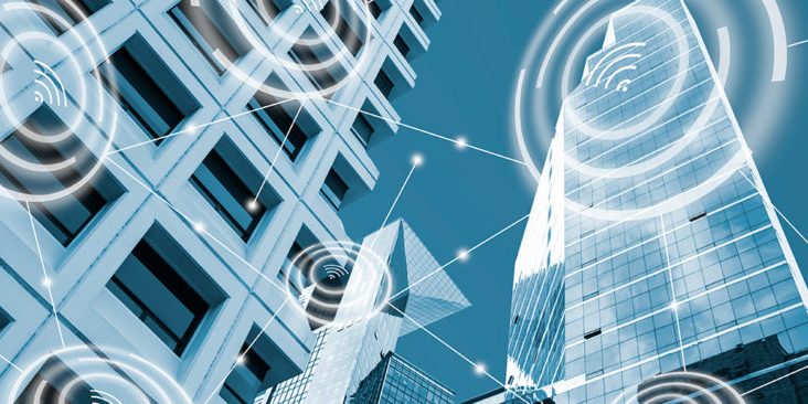 Wifi icon and low angle view modern office buildings in blue tone  with network connection concept,  smart city and wireless communication network, IOT internet of things conceptual image